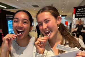 Young women completing cheek swabs to join the stem cell donor registry