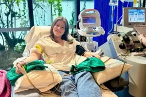 Abbey smiling while donating stem cells in hospital