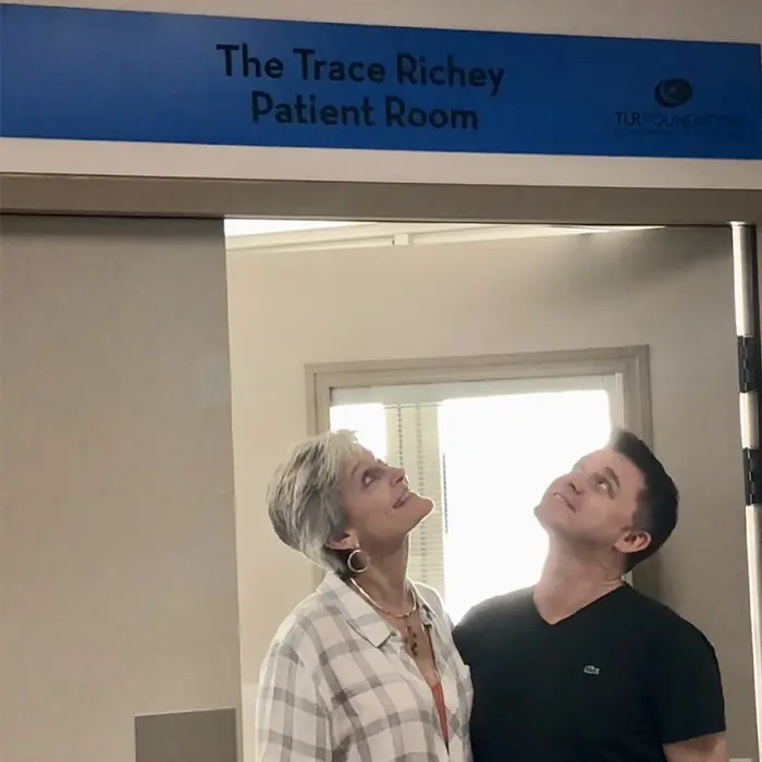 TLR’s co-founder Neil and Trace’s sister Brenda standing in the doorway of the Trace Richey Patient Room at St Vincent’s Hospital Sydney, looking up at the plaque above the door