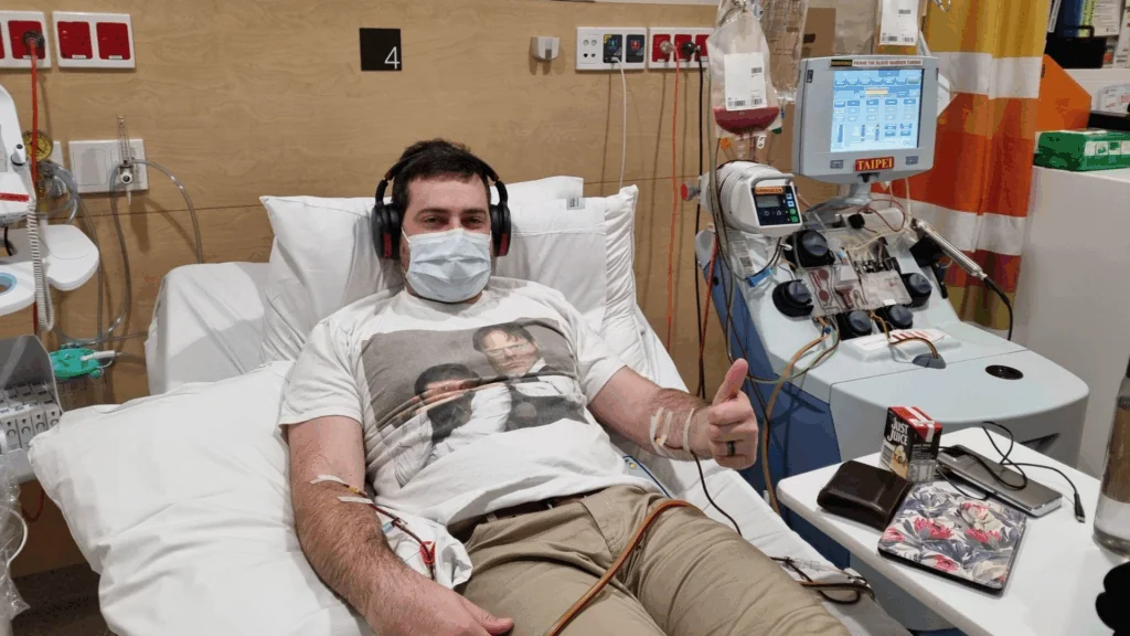 PBSC stem cell donor Nick apheresis machine Stem cell donor Nick connected to an apheresis machine giving a thumbs up during PBSC donation