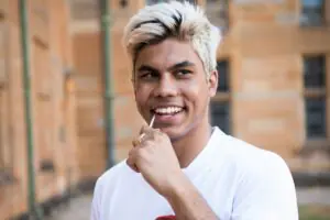 A young man using a cheek swab to join the stem cell donor registry