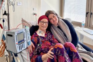 Abbey and her mum Maggie smiling together during her stem cell transplant in hospital