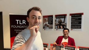 A young man using cheek swabs to join the stem cell donor registry.