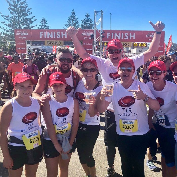 TLR supporters of all ages celebrating after crossing the City2Surf finish line together.