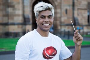 Young Australian holding a cheek swab kit before joining the stem cell donor registry