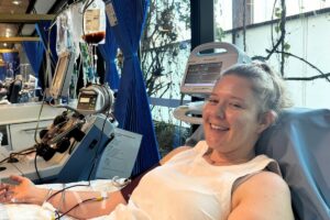 Abbey donating stem cells with the collection bag visible behind her